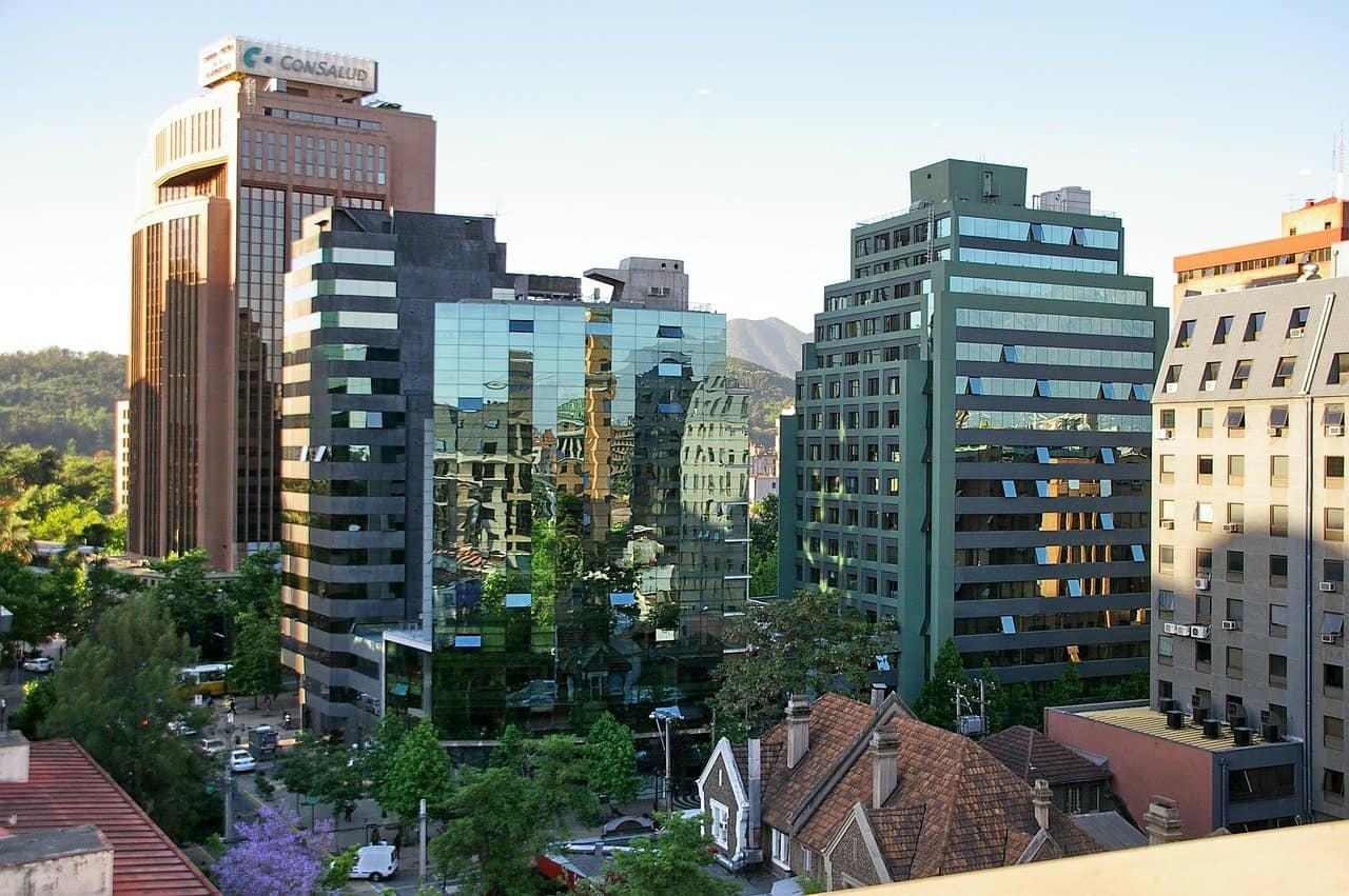 Cluster of glass and concrete office buildings in a city with trees at street level